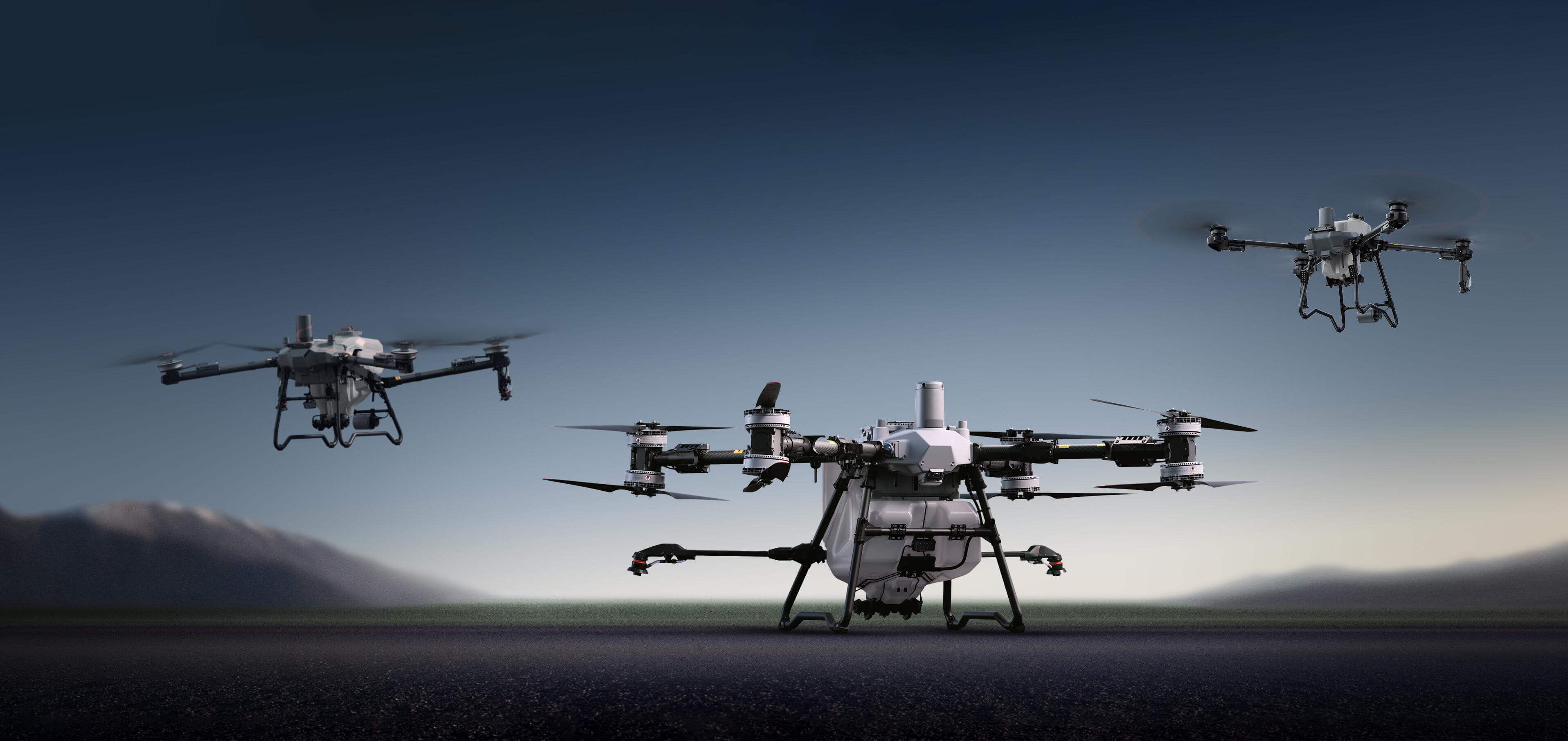 DJI Agras T100 agricultural drone (center) with the T70P and T25P, official DJI press image
