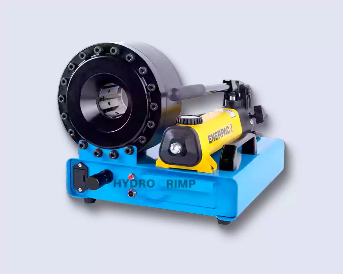 The HYDROCRIMP HC-P16MP manual hose crimper on a light background: a blue base with a die drawer and indicator light, a black sixteen-bolt crimping head with its die segments open, and a yellow Enerpac hand pump bolted alongside
